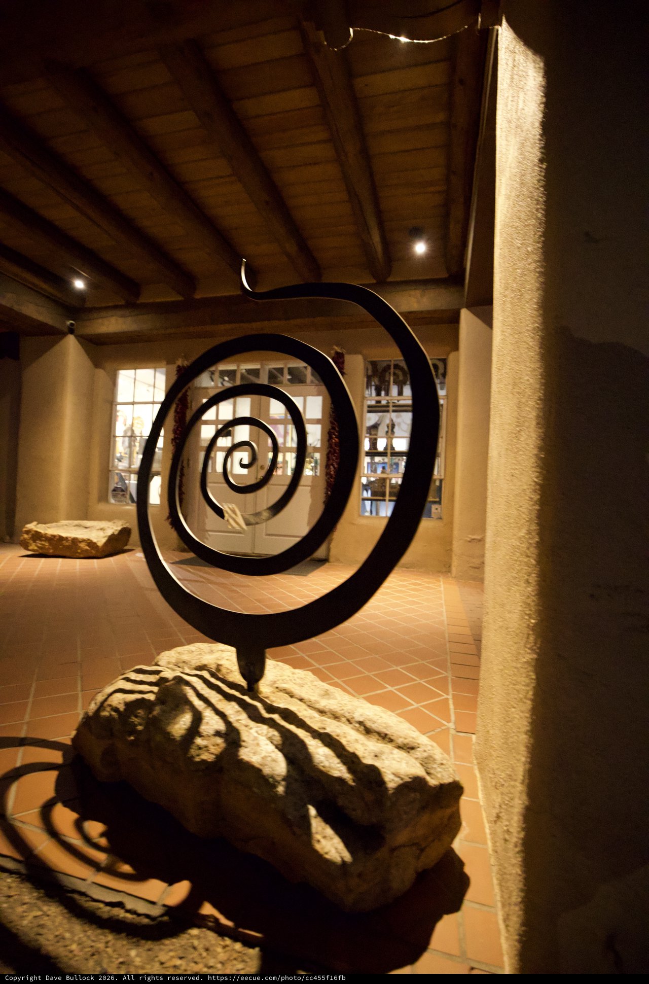 Black Metal Spiral Sculpture in Gallery Setting