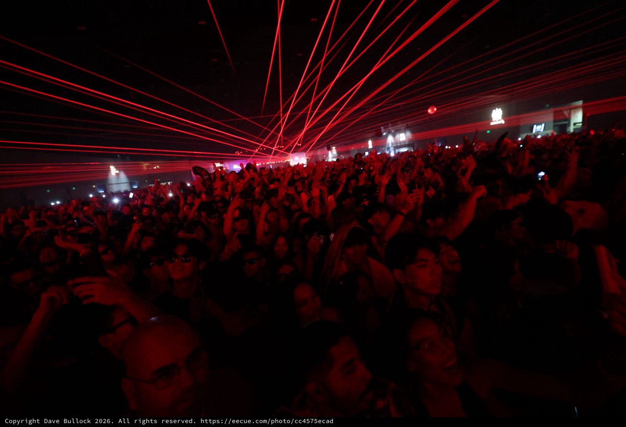Red Laser Storm Over Massive Dance Music Crowd