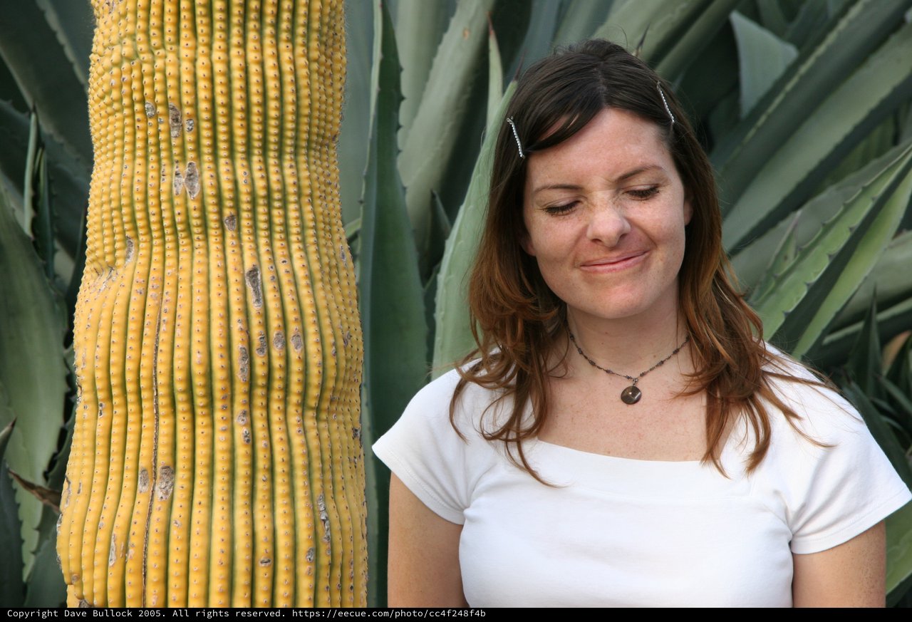 Woman Smiling Beside Desert Cactus and Agave