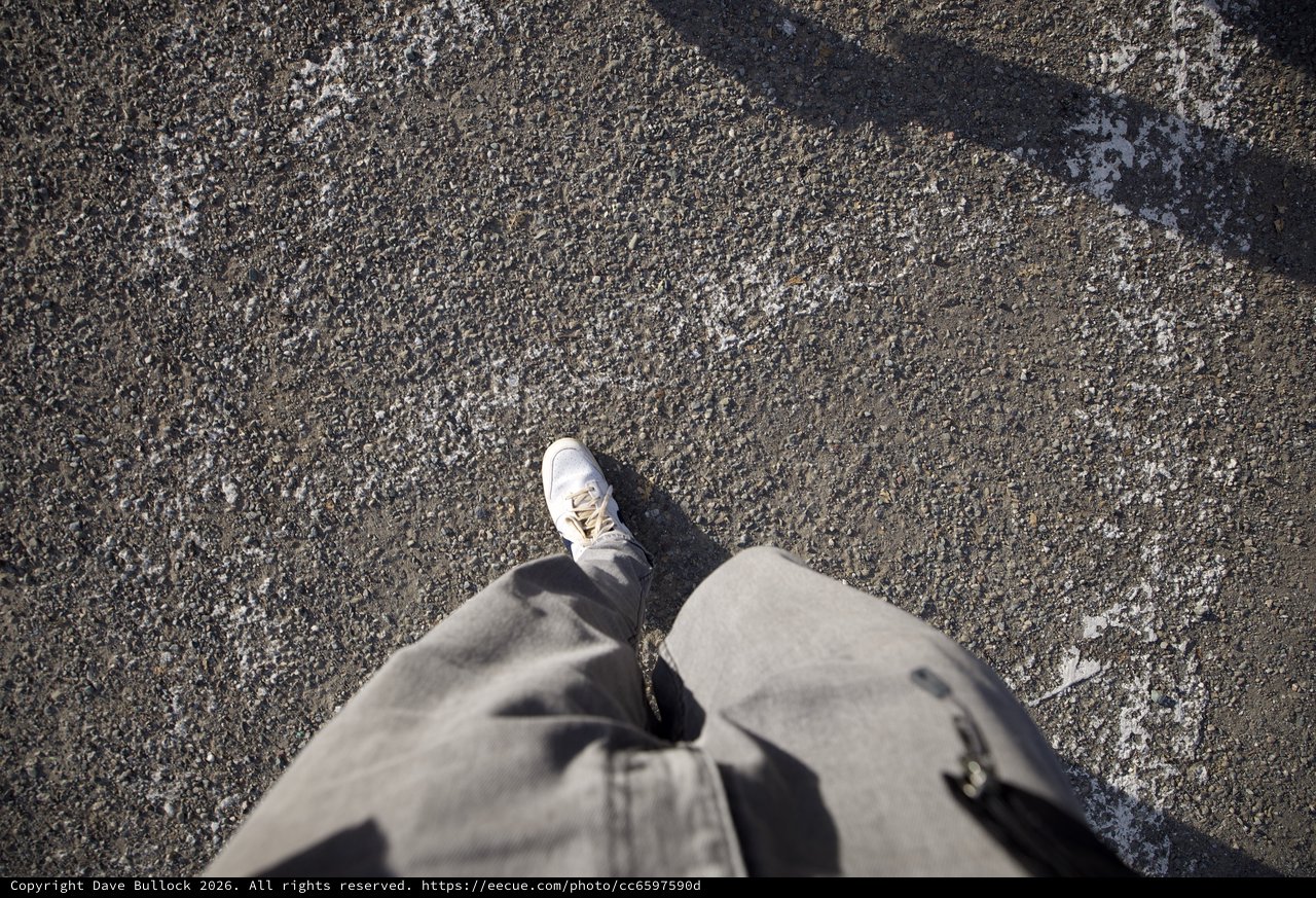 Point of View: Walking Alone on Weathered Asphalt