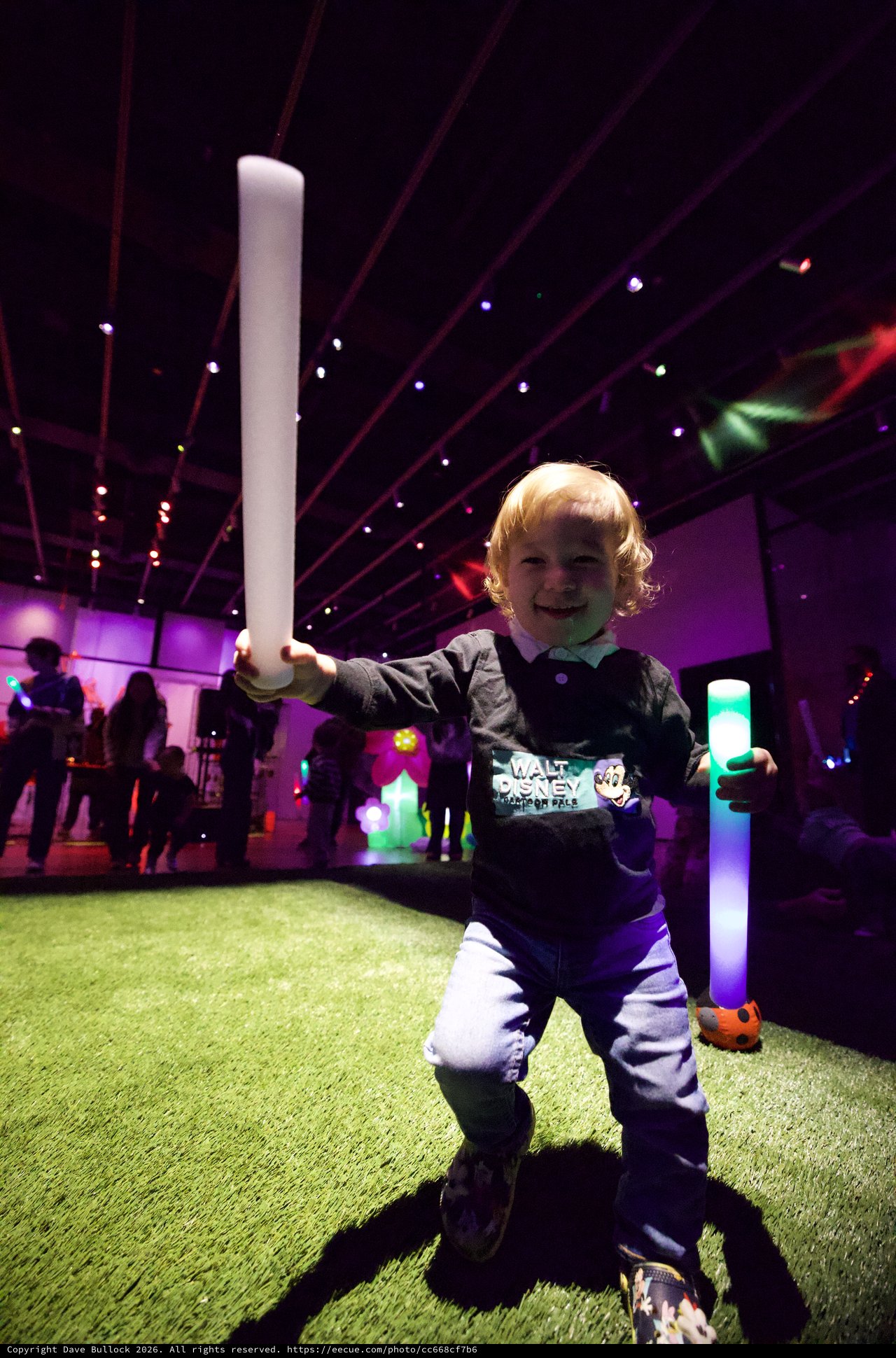 Young Child Enjoying Baby Rave with Glowing Foam Batons