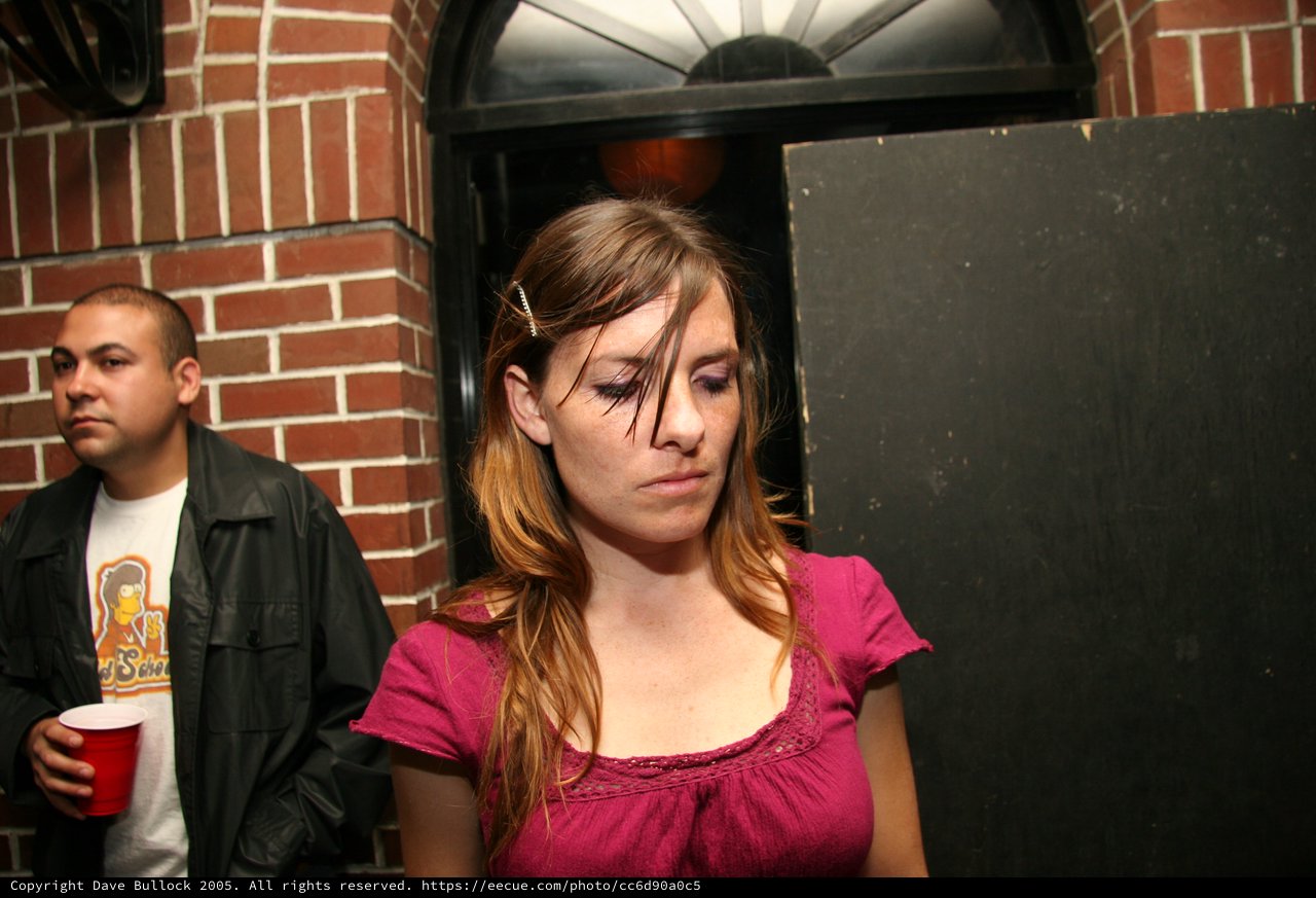 Young Woman at Late Night Party Looks Down