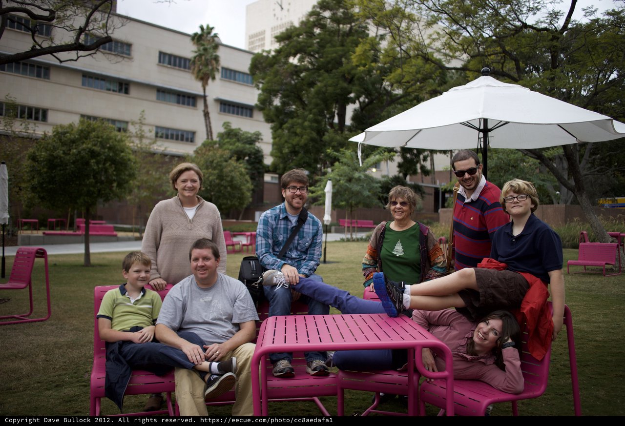 Family Gathering on Pink Outdoor Furniture at Dusk