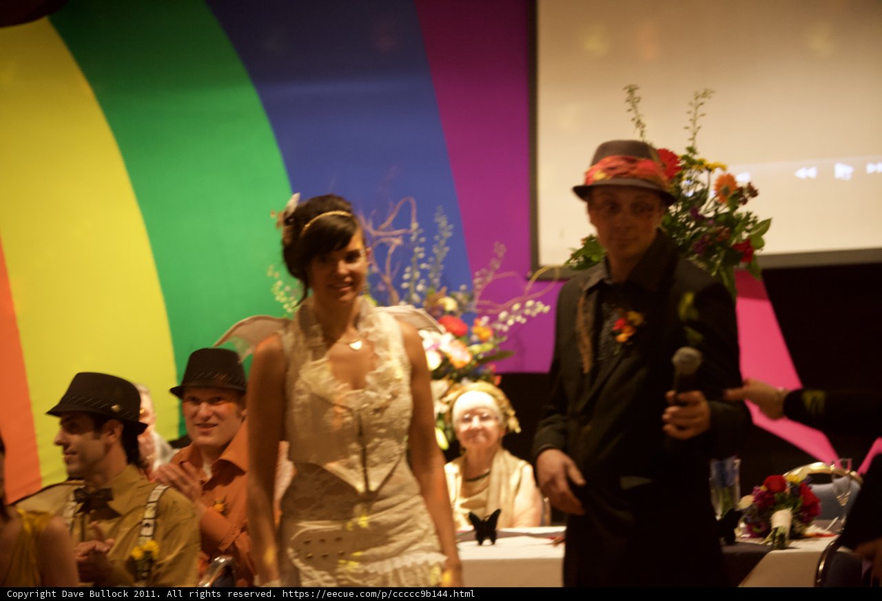 The Happy Couple with Their Gorgeous Flower Arrangement
