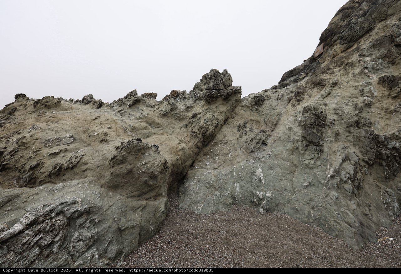 Jagged Coastal Cliffs Rise Against Overcast Sky