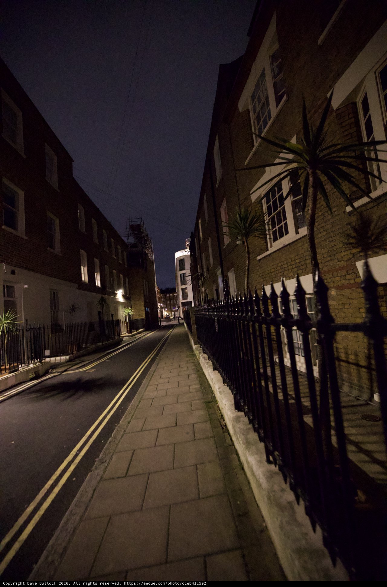 Dark London Street at Night with Iron Railings