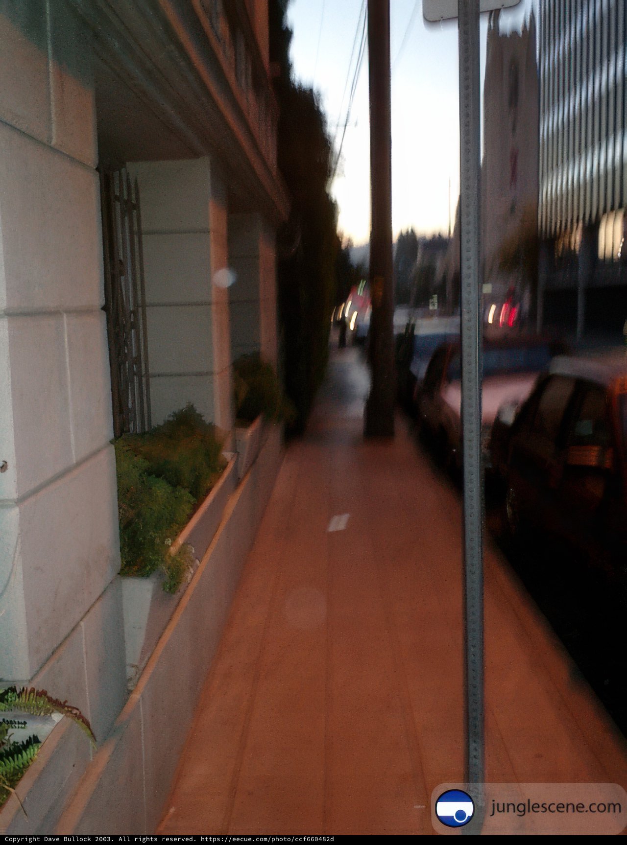Blurry City Street with Parked Car