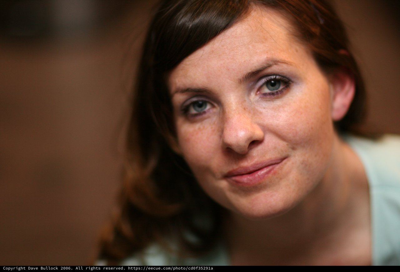 Freckled Woman with Blue Eyes Gentle Smile
