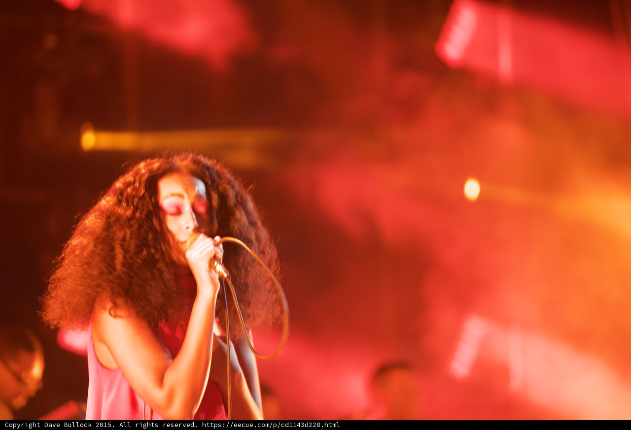 Solange Portrait Eyes Closed Singing Red Orange Haze Serene