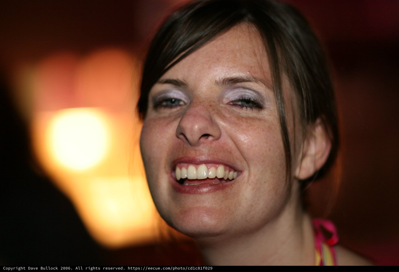 Joyful Woman Laughing in Warm Ambient Light