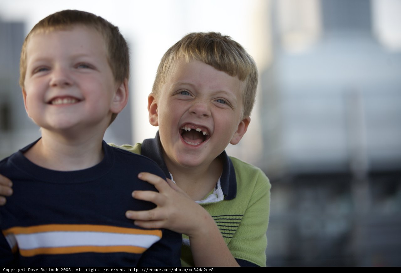 Two boys enjoy the city skyline