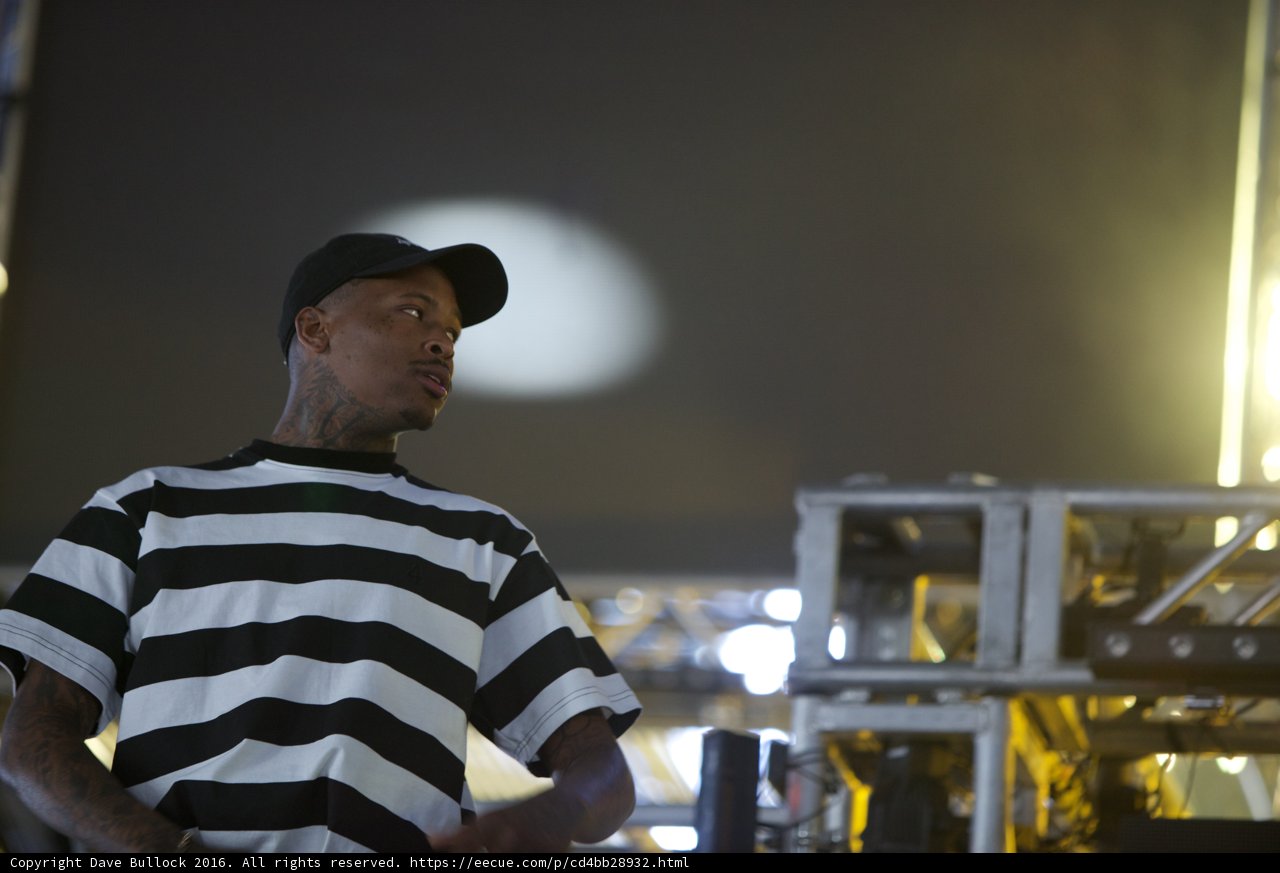 YG rocks the Coachella stage in striped shirt and hat