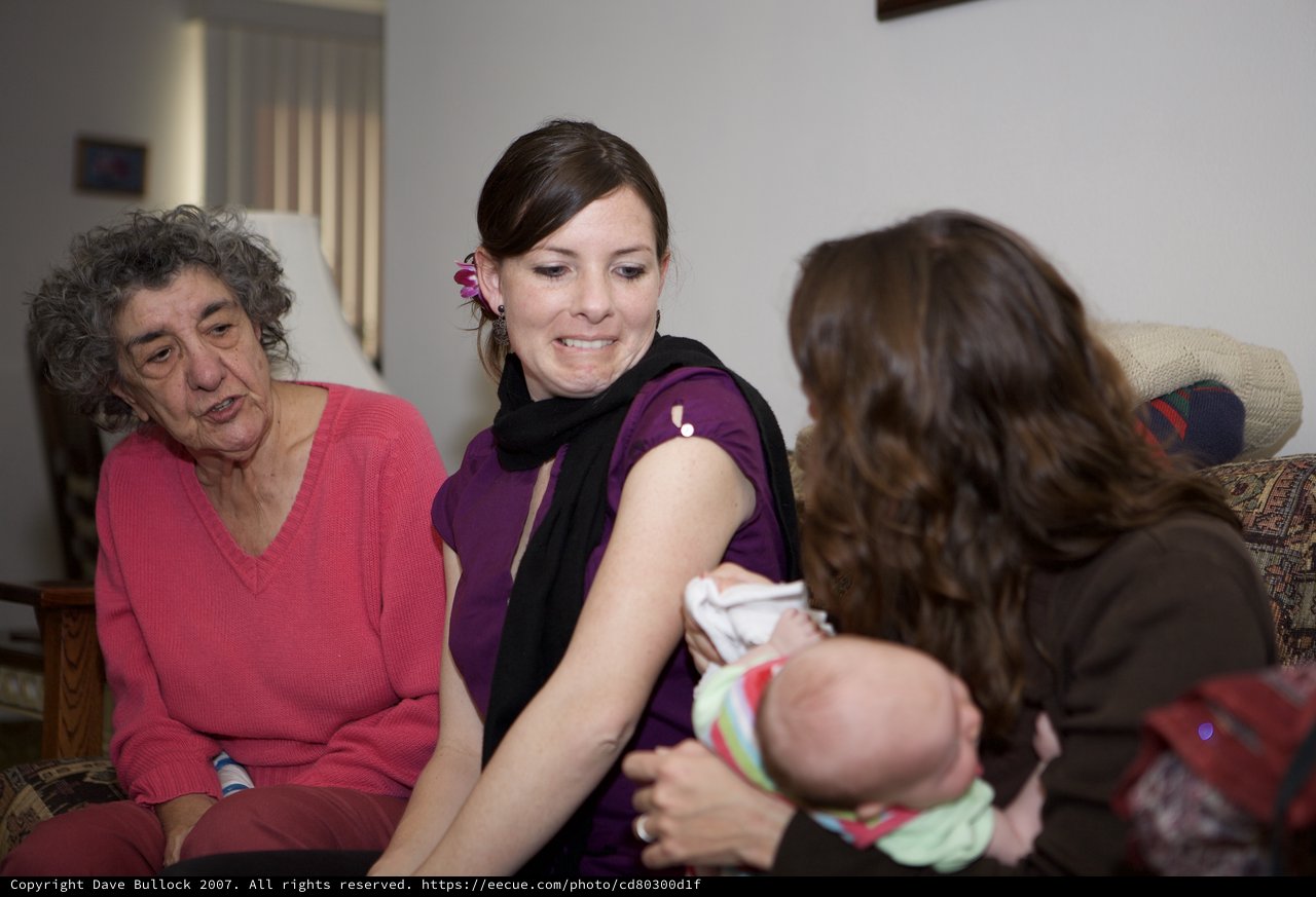 Three Generations Share Tender Moment With Newborn