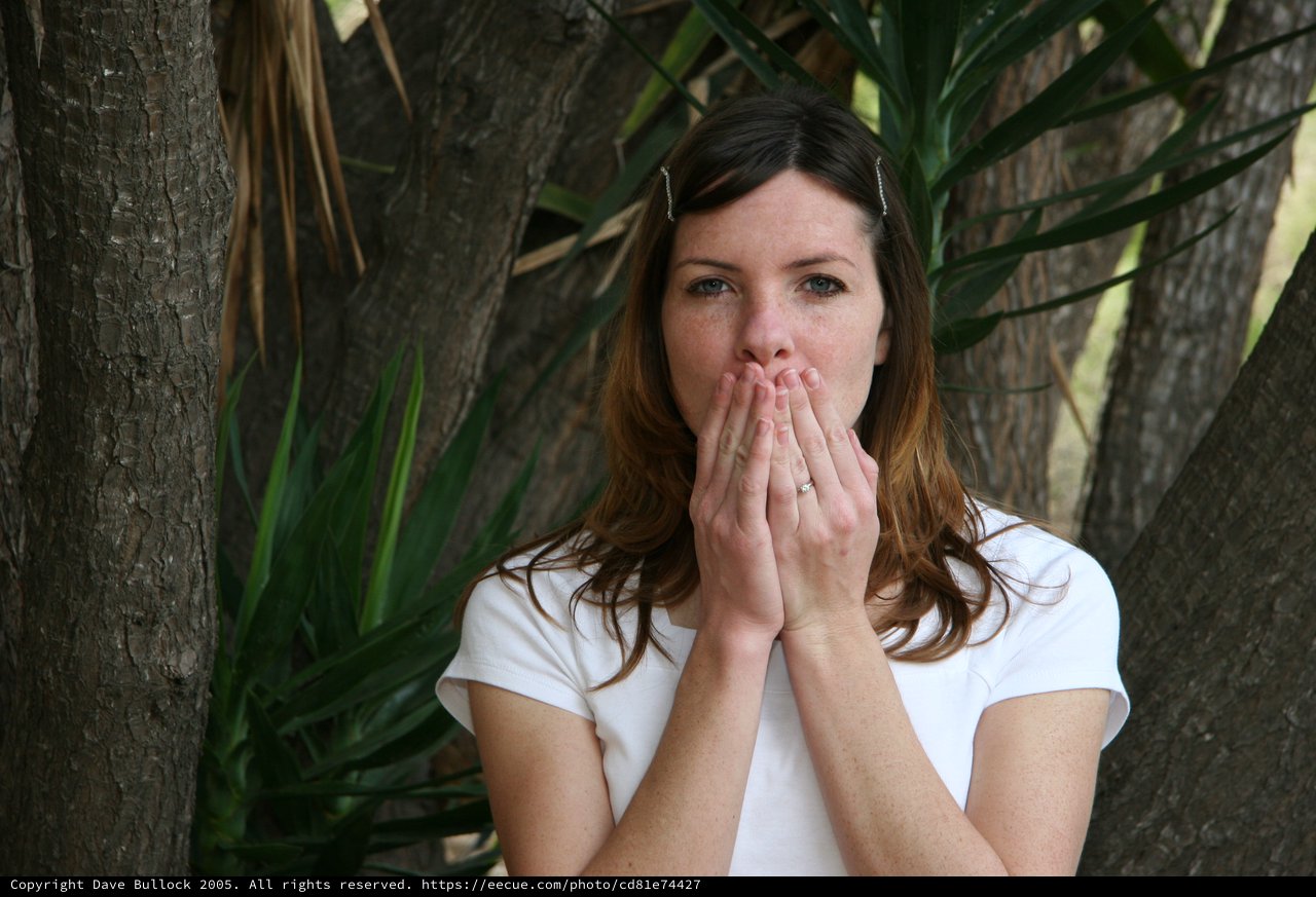 Woman in Surprise Outdoors Among Trees