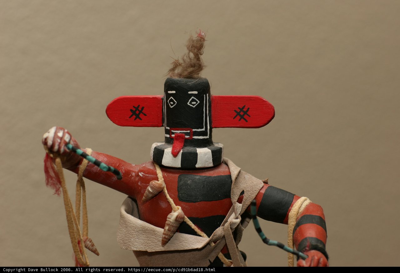 Native American Figurine with Red and Black Headdress