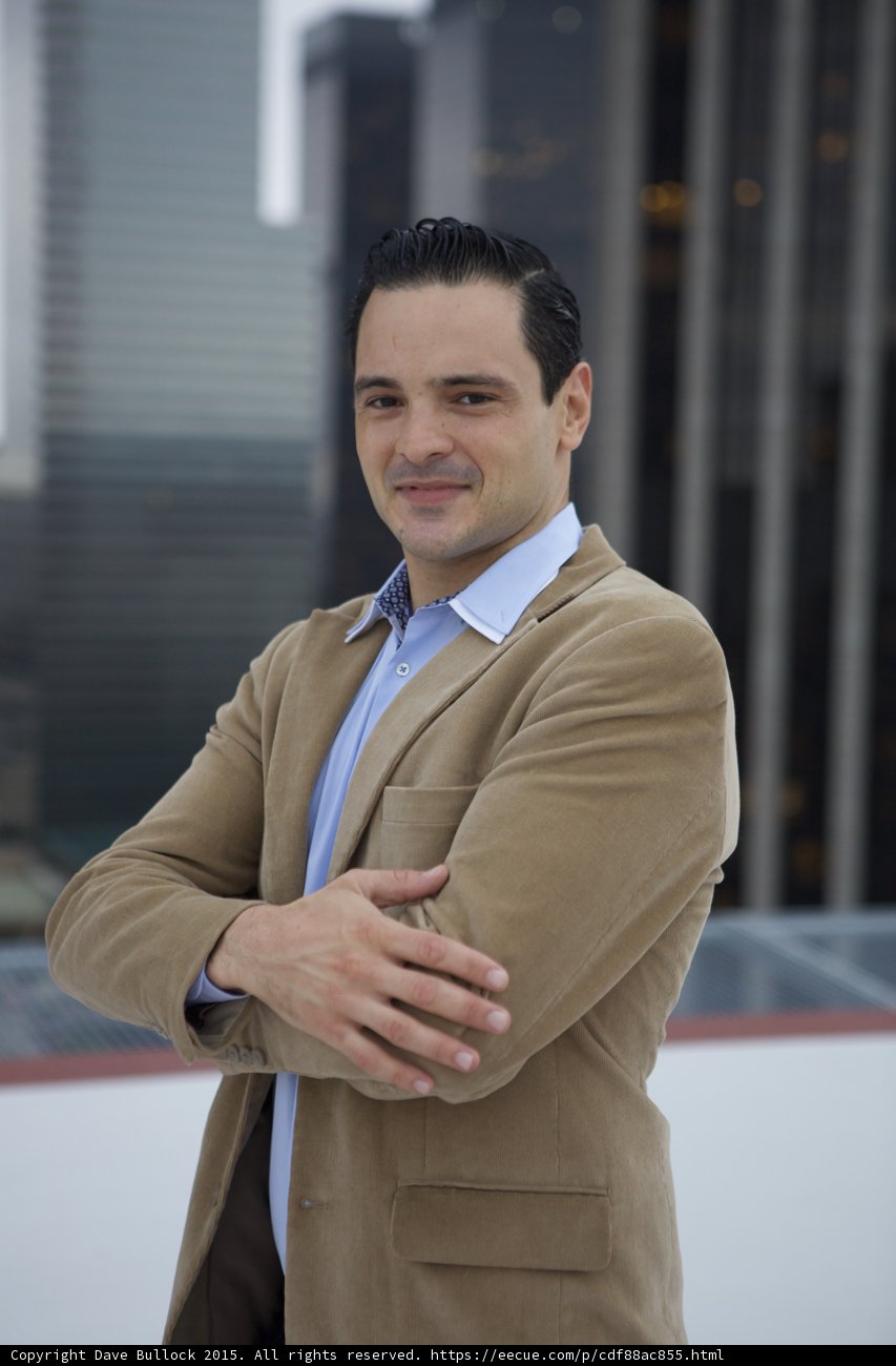 Dapper Man in Tan Suit and Blue Shirt Strikes a Pose
