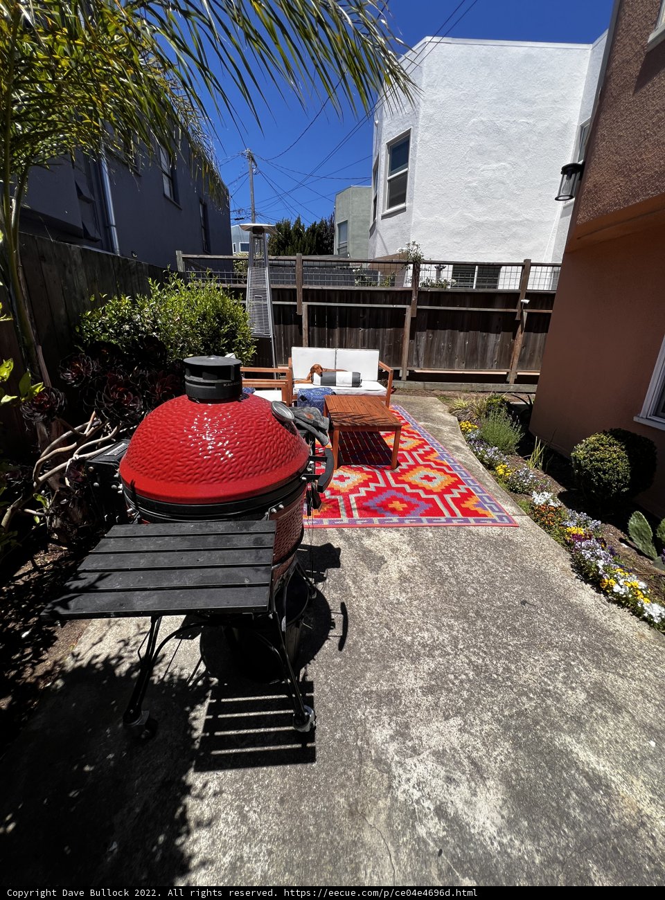 Red BBQ Grill in a Lush Backyard Setting