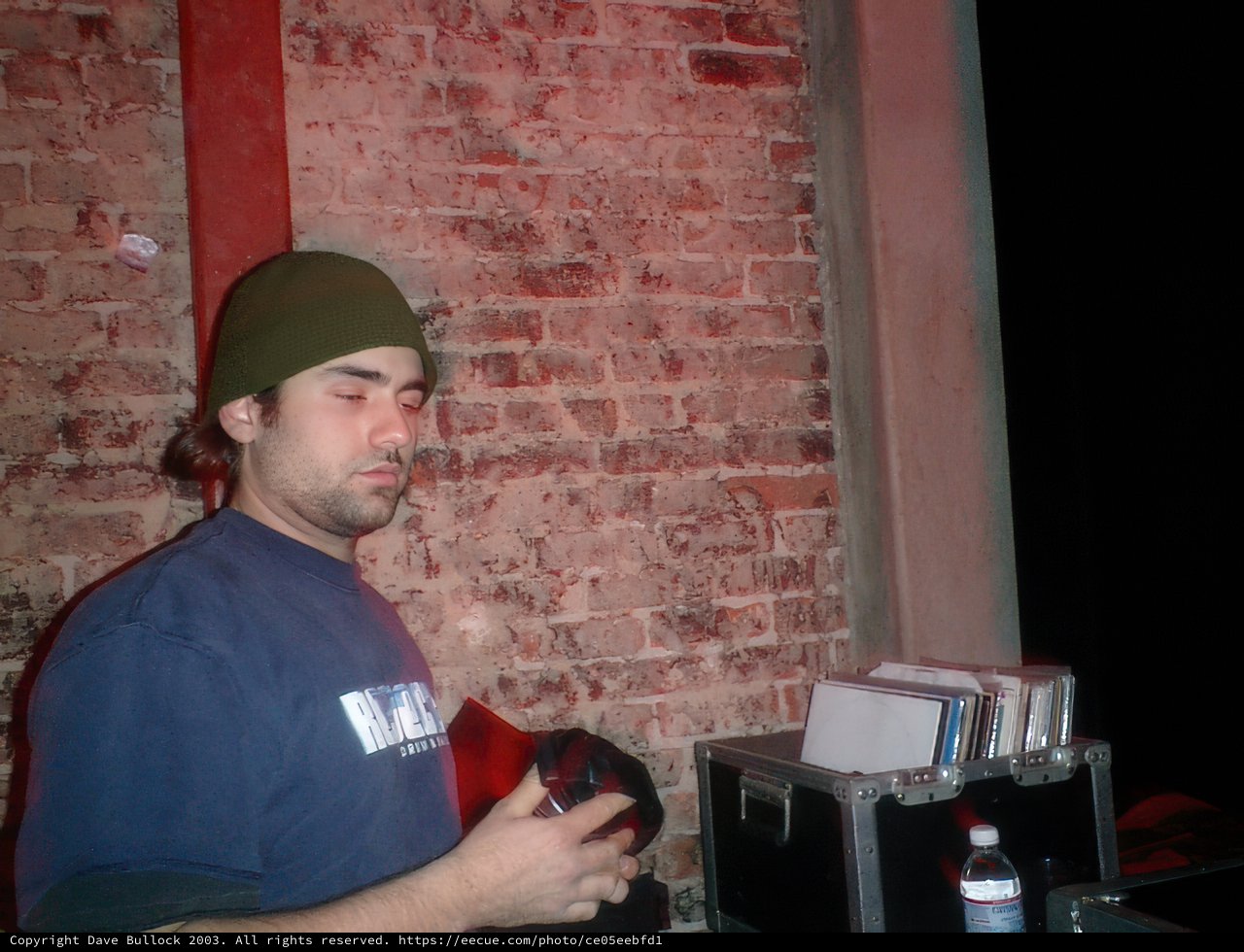Beanie-clad Man Enjoys a Drink at the Pub