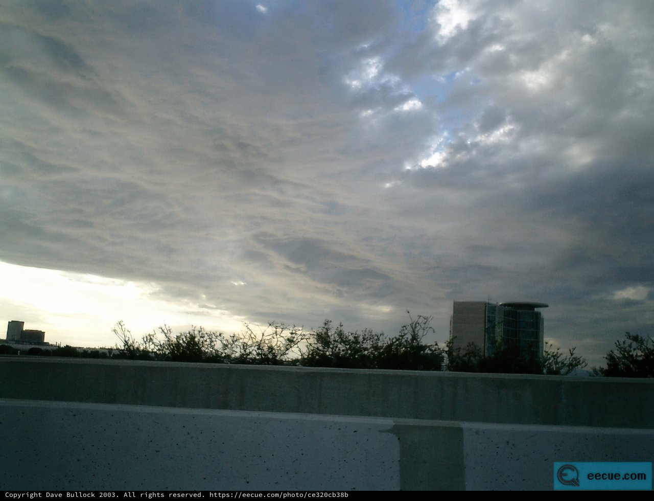 Majestic Cumulus Clouds over City Building