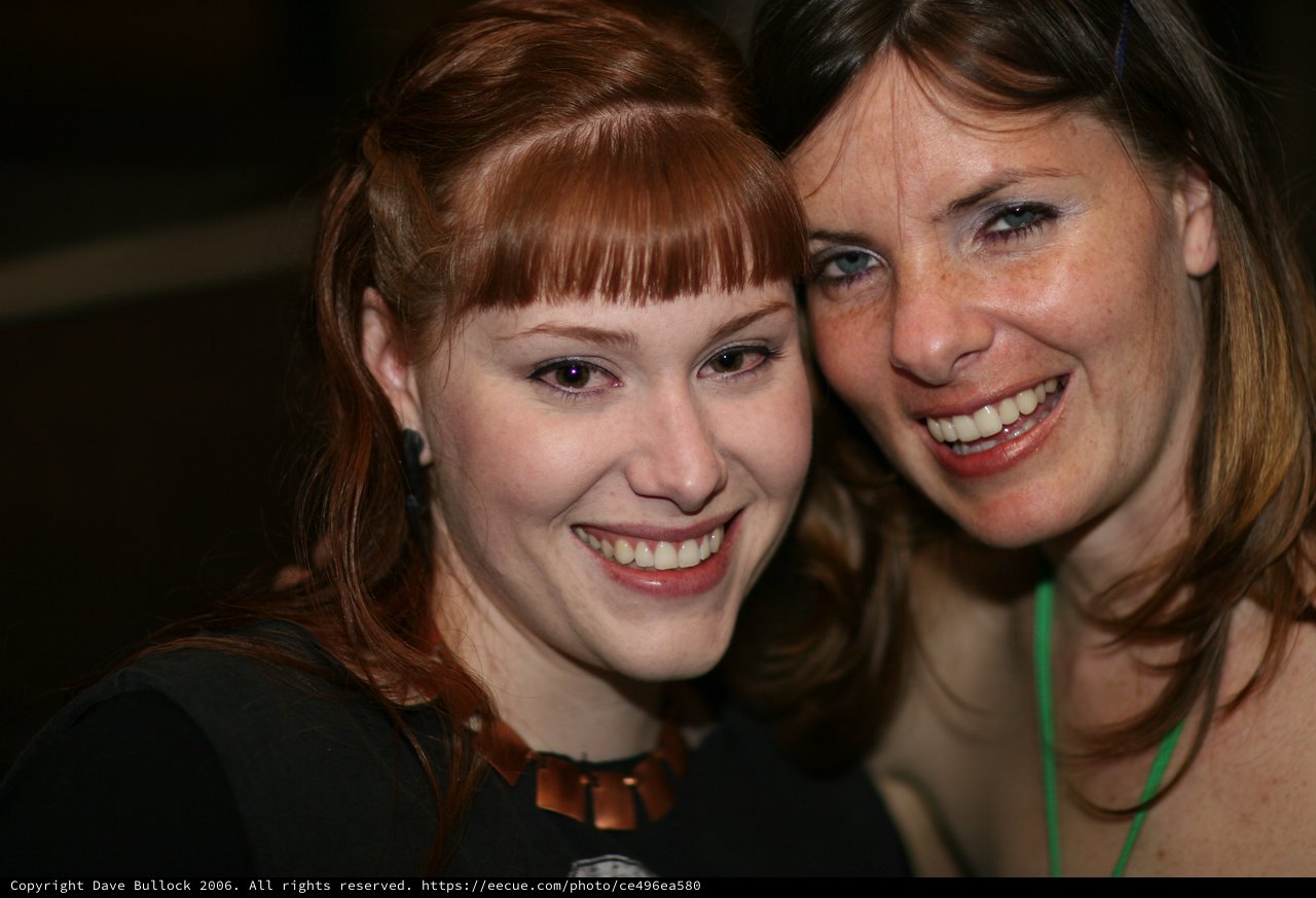 Two Smiling Women Pose Together at Event