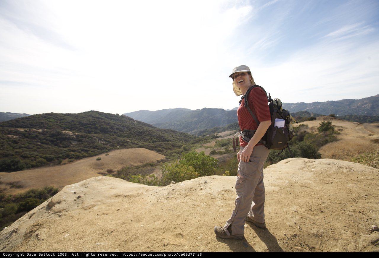 Joyful Hiker Atop Rocky Overlook in California Hills