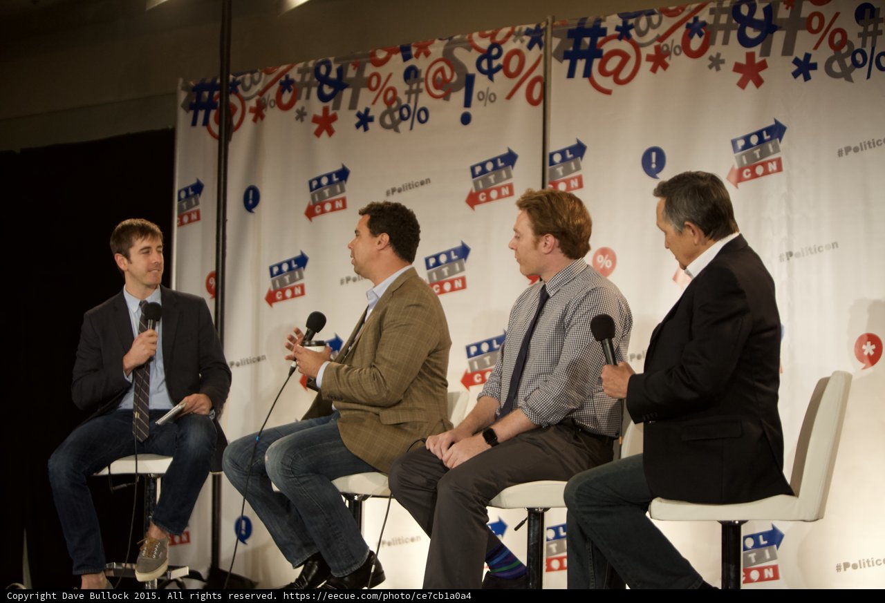 Four Men Discussing Politics in Chairs