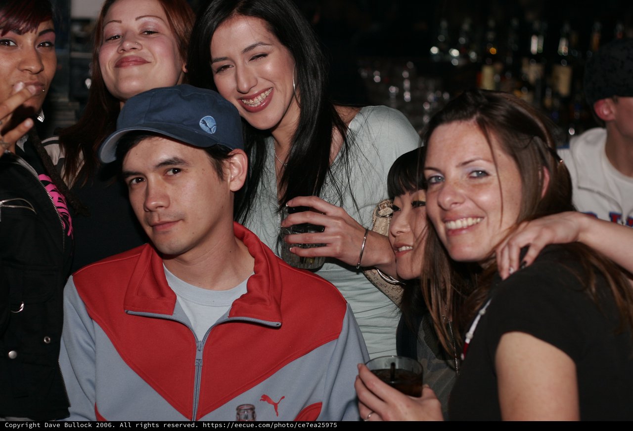 Friends Posing Together at a Nightclub Bar