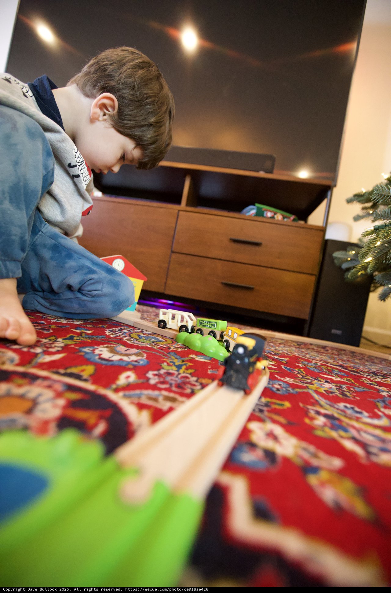 Child Playing with Wooden Train Set on Christmas