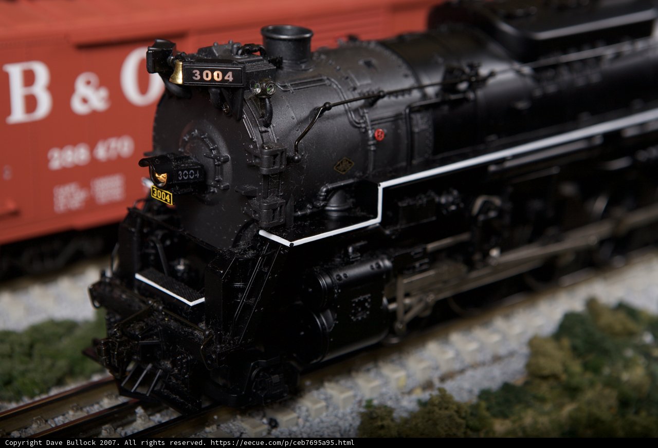 Black Locomotive and Red Train on Railway