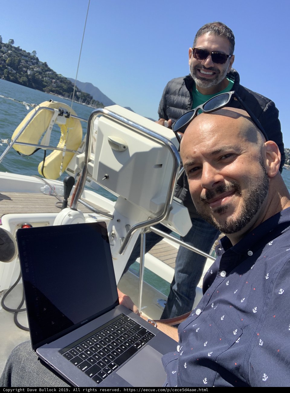 Two Men on a Laptop-Filled Yacht