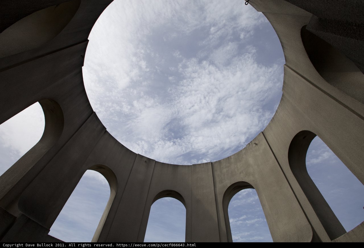 Sky peering through a building's hole