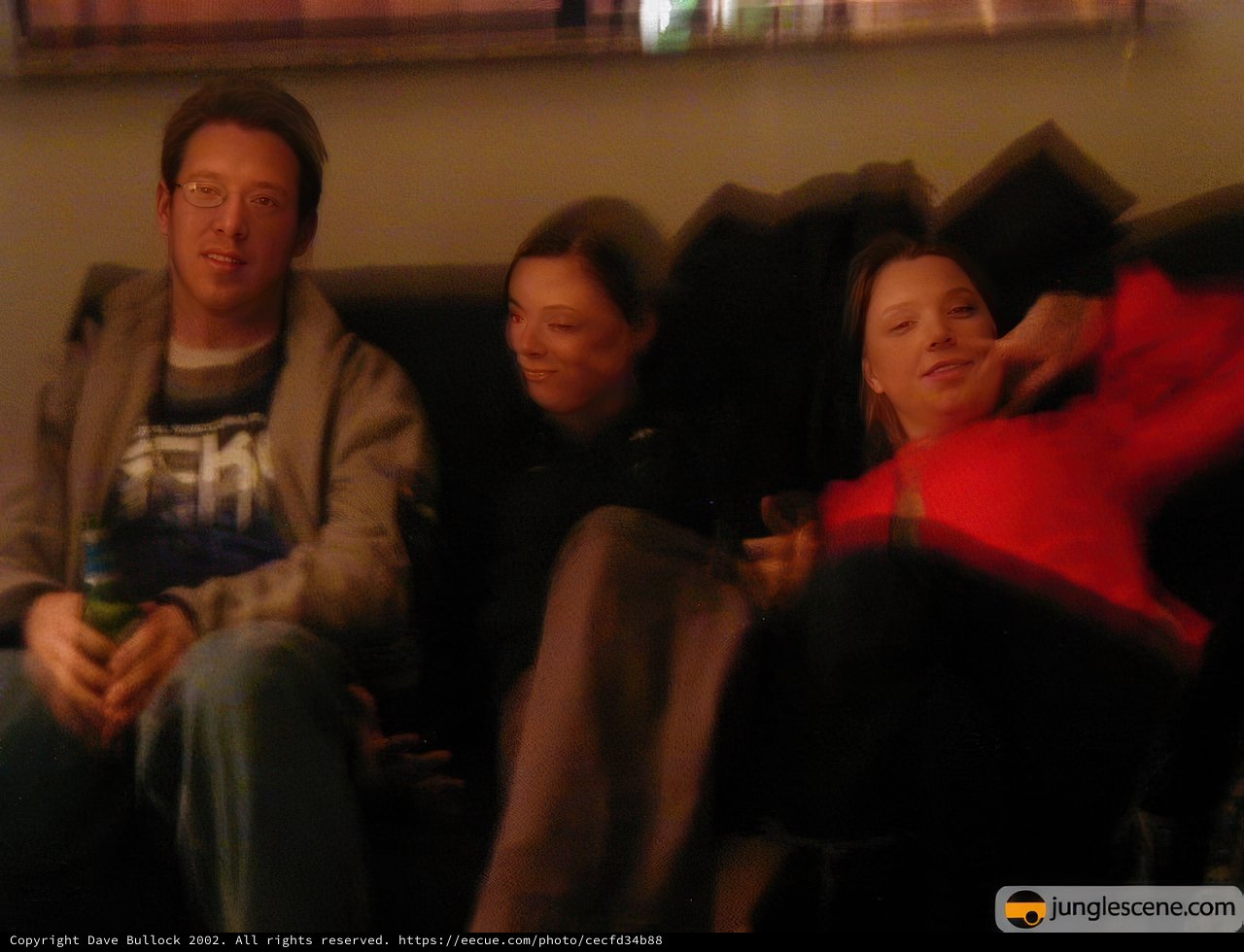 Three Happy People on a Cozy Couch
