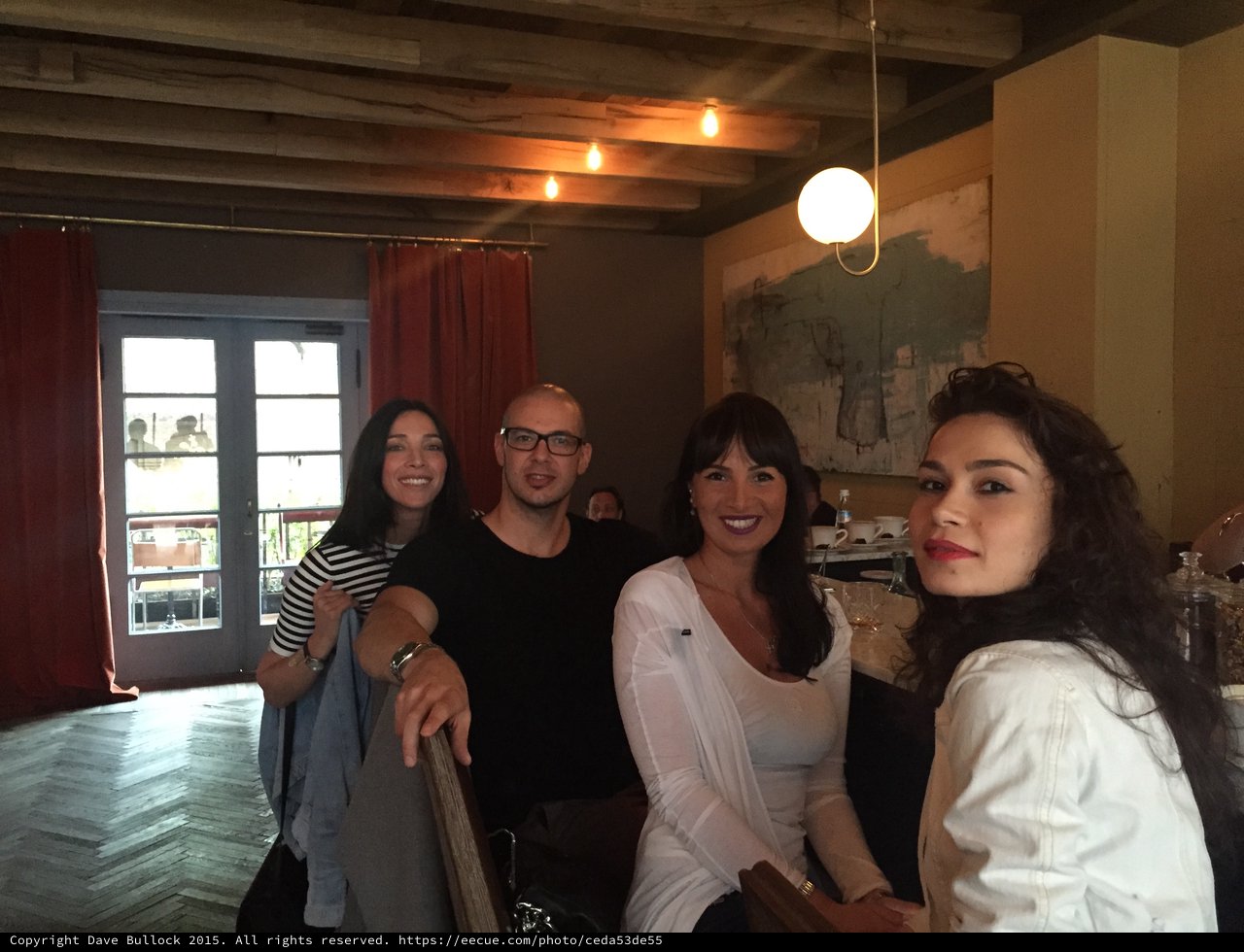 Four Friends Gathered in a Rustic Restaurant Interior