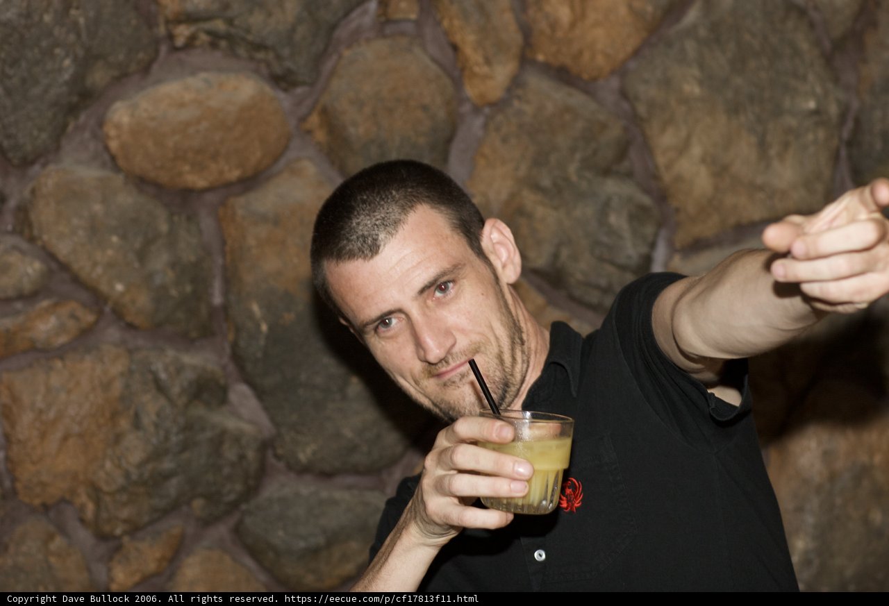 Man enjoying a refreshing drink by the wall