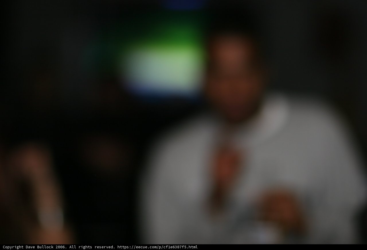 Blurred Man in a Dark Room Surrounded by Electronics