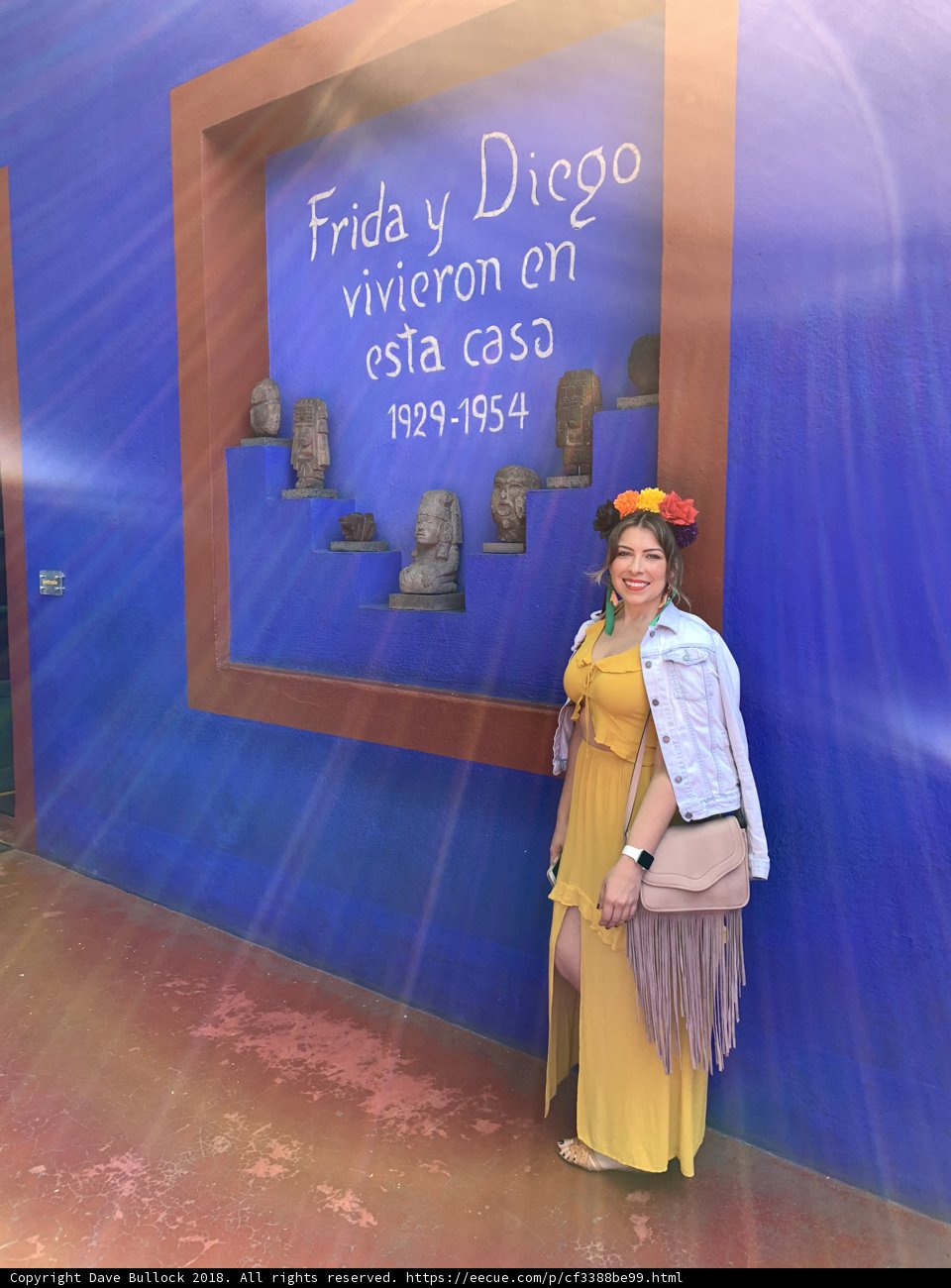 Yellow dress against a blue wall