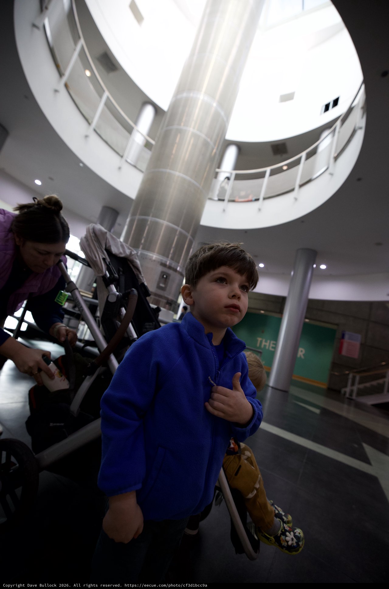 Young Boy in Blue Hoodie at Science Center