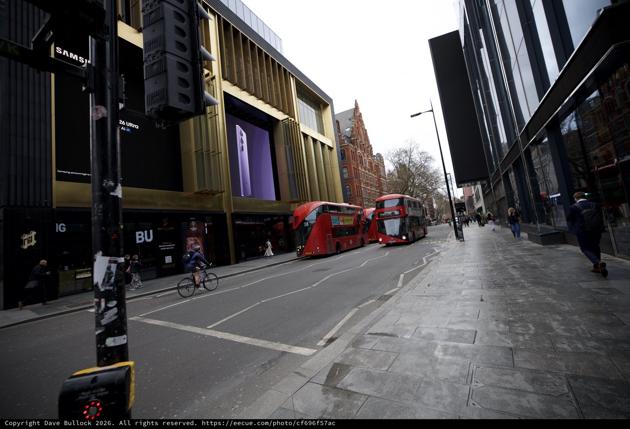 Modern Shopping District with Red Double-Decker Buses