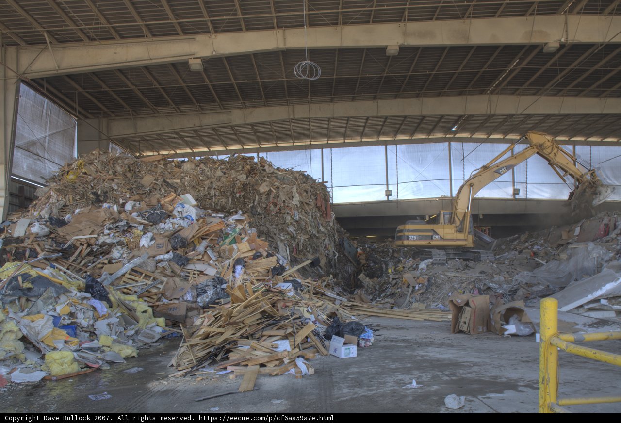 Garbage Pile in Warehouse with Bulldozer