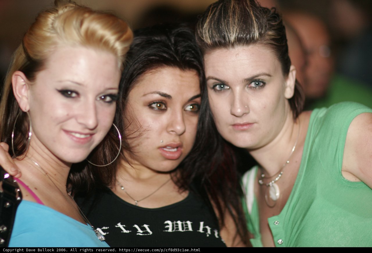 Three Women Strike a Pose in Urban Club