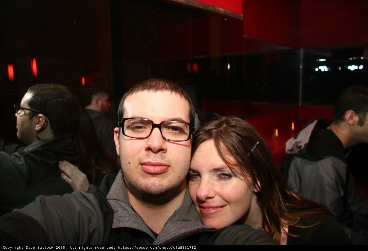 Couple Poses Together at Dimly Lit Nightclub