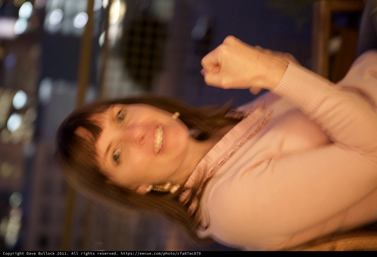 Joyful Woman Smiling at Night Cityscape