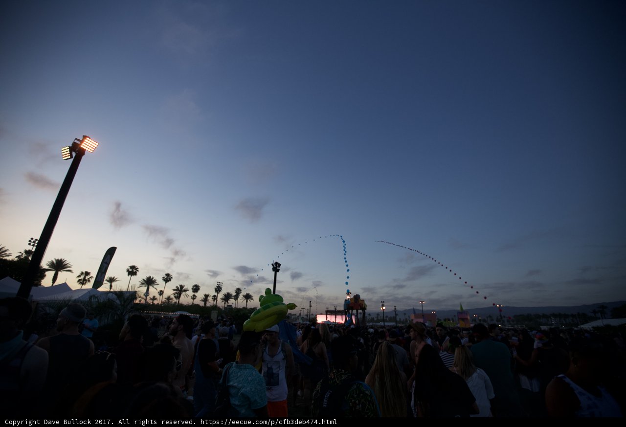 Crowd at Coachella under a Flare-Lit Sky