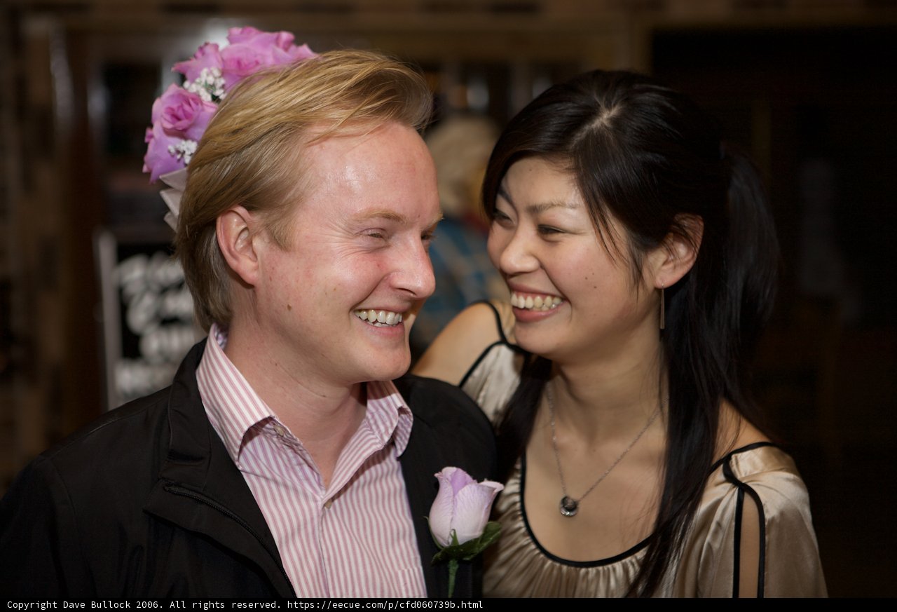 Smiling Bride and Groom amidst Flower Arrangements