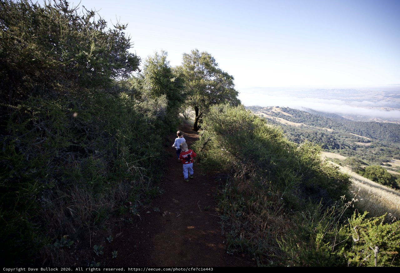 Young Explorers Hiking Ridge Trail Above the Clouds