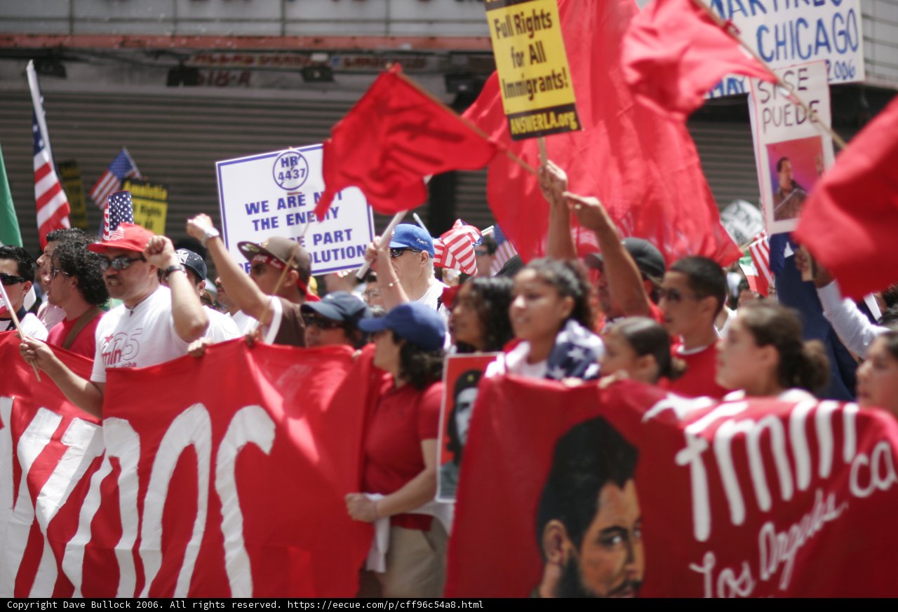 Protesters Hold red Flag and Signs