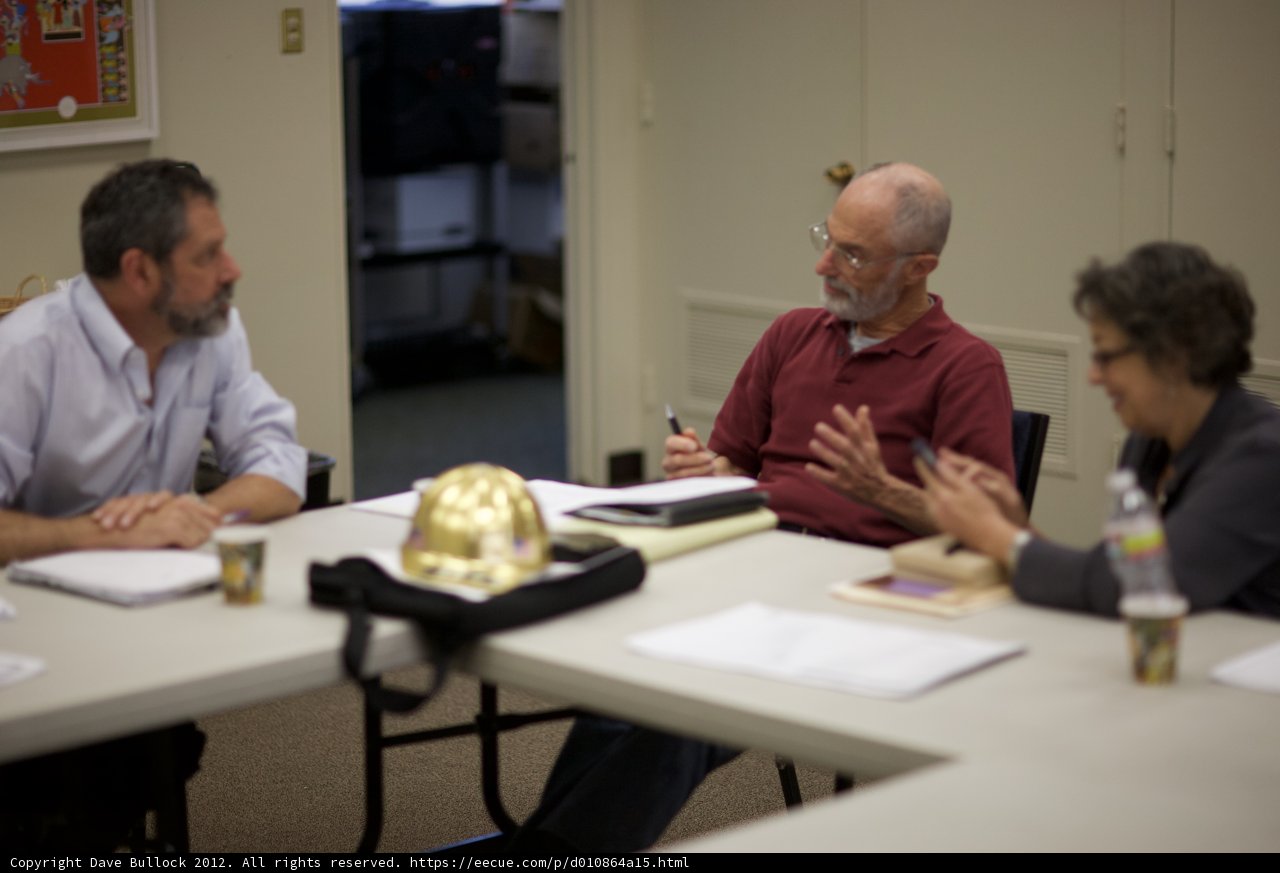 Three People Engaged in a Productive Discussion