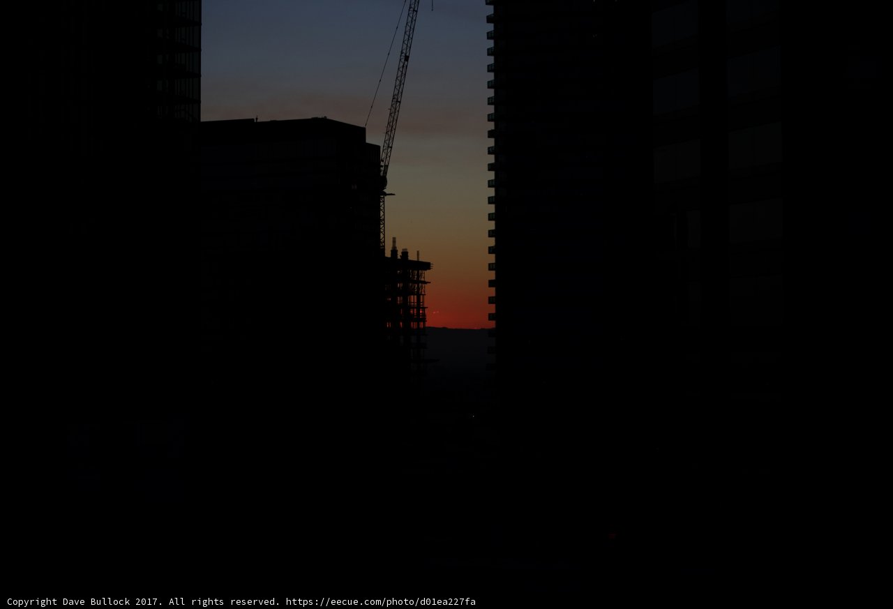 A Silhouette of Urban Construction at Sunset