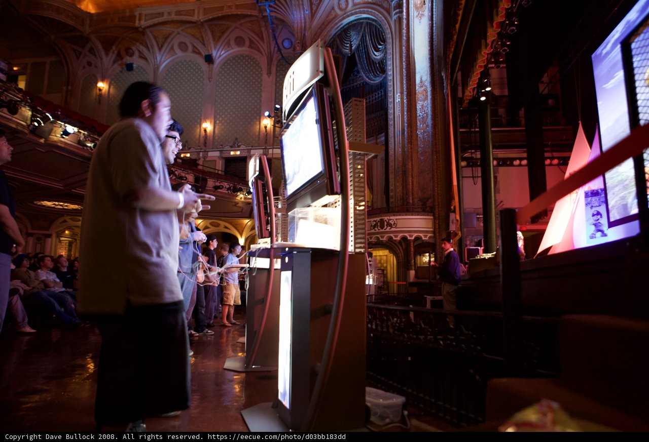 Man Enjoying Gaming on Large Screen at Pub
