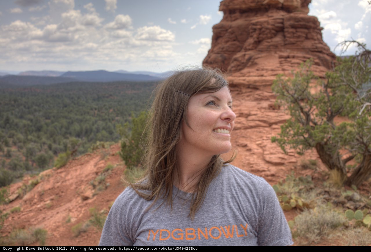 Woman Smiling Atop Red Rock Formation in Sedona